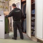 gerson relocation team member tidying up the assignee's closet - improved image brightness