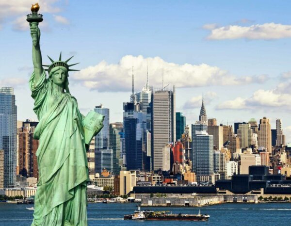 The statue of liberty with new york city in the background