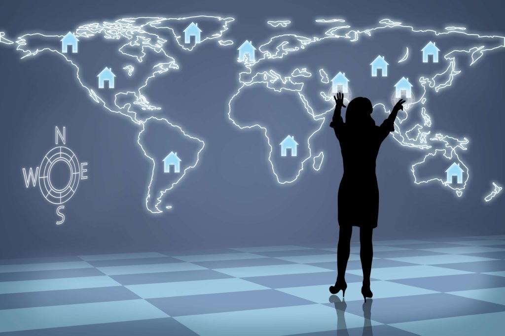Woman in silhouette standing in front of a map with house icons on