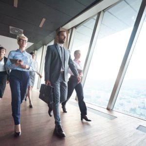 business team, businesspeople group walking at modern bright office interior