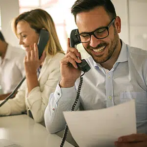 Man and woman on the phones in an office