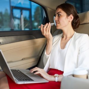 businesswoman-working-in-car-5LRQ6HU-web