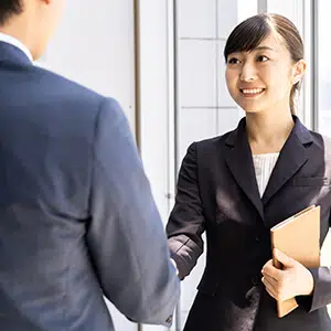 Man shaking hands with a lady in a professional environment