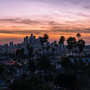 Los Angeles at sunset with houses and skyscrapers in the background