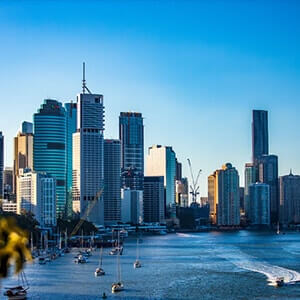 Buildings of Brisbane’s central business district over boats on the Brisbane River