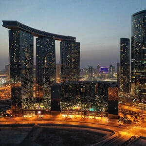 View of the lit-up roads and buildings of Al Reem Island, Abu Dhabi at dusk