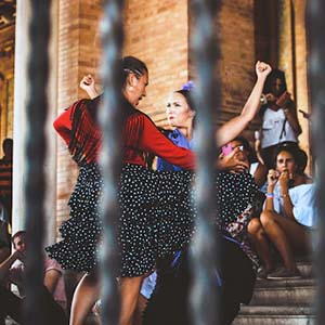 A traditional Spanish dance-off with two ladies and an audience watching in the background