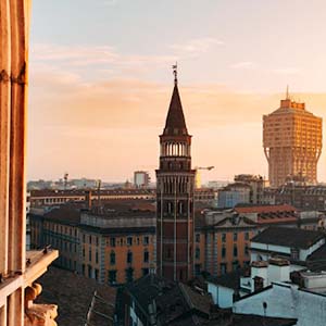 A view from a window of Il Duomo, Milan, across the roofs of Milan at sunset