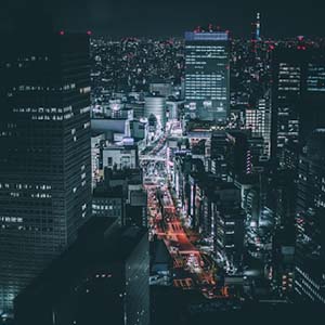 Night Time Tokyo with lights in the skyscraper windows and traffic lighting up the streets