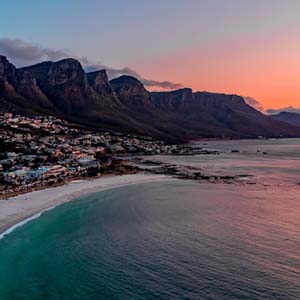 Sunset over the mountain range behind Cape Town and its beaches
