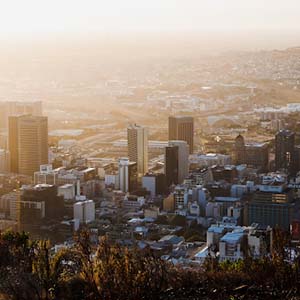 The sun rising over the city of Cape Town with buildings extending to the horizon