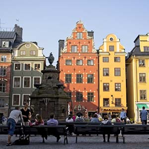 Colourful ornamental buildings in a square in Stockholm full of people