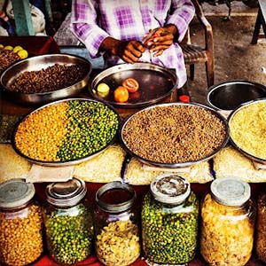 Glass jars and metal dishes with Indian spices and other dry foods