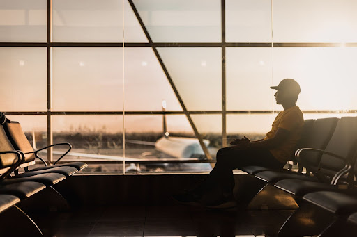 Man sitting in the waiting area of an airport.