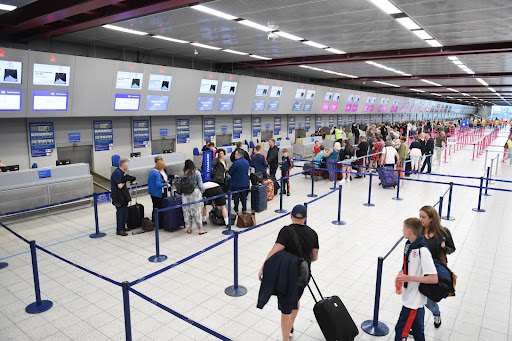 People queuing for the check-in desks at an airport.