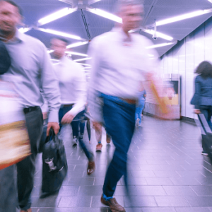 People walking quickly through an airport terminal