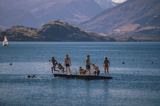 Group of friends having fun on the lake in New Zealand