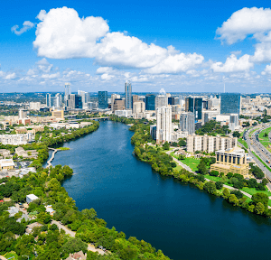 Austin Texas on a sunny day with a lake and city skyline view