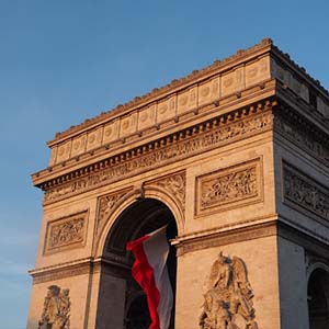 French flag on the side of Arc du Triumph in Paris