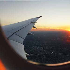View of a plane wing at sunset from an aeroplane window