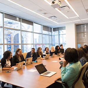 Team of people working at a boardroom table in an office