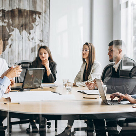 group of people working out business plan in an office group of people working out business plan in an office