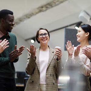 Employees celebrating the success of another colleague