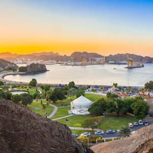 View of Muscat’s jagged coast at sunrise in Oman from a rocky hill