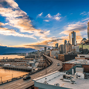 Sunset over the buildings by the harbour in Seattle