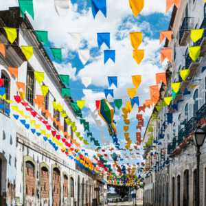 Colourful paper decorations hanging over a street between buildings in the historic city of Sao Luis, Maranhao State, Brazil