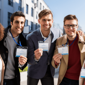 An international group of people with conference badges on city streets