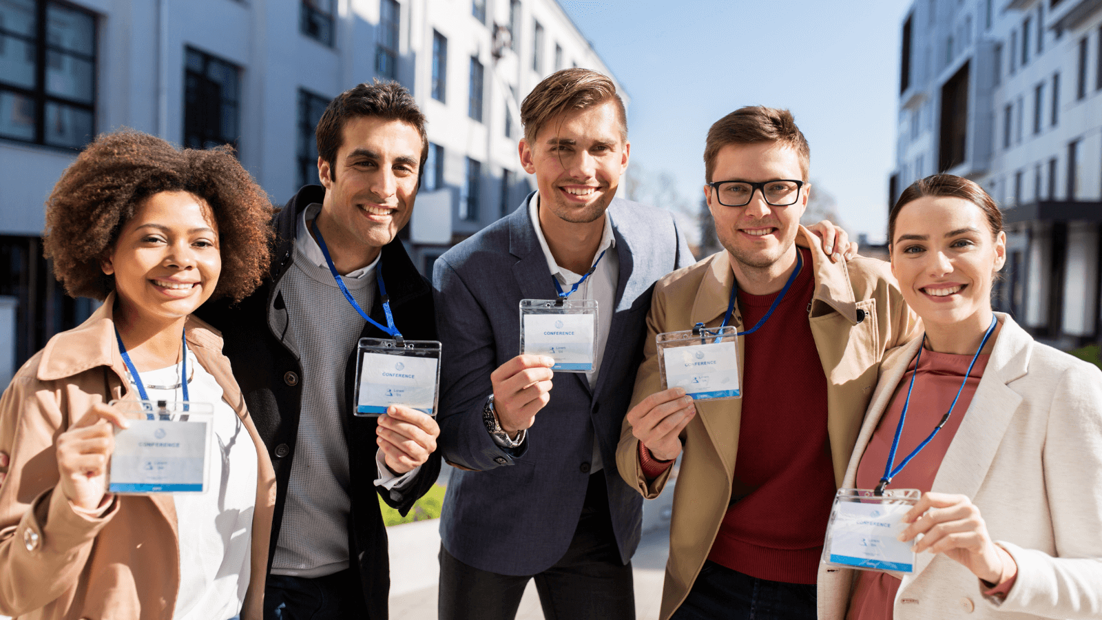 An International Group Of People With Conference Badges On City Streets