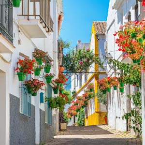 A residential street showing houses with hanging flower pots in the Spanish town of Estepona in Malaga
