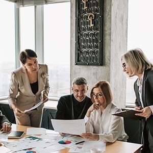 A group of corporate individuals brainstorming in a meeting room