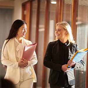 Two female employees walking a corridor