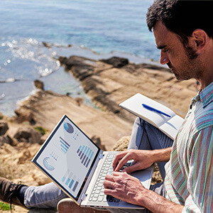 A man working remotely in a coastal location