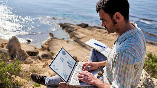 A Man Working Remotely In A Coastal Location