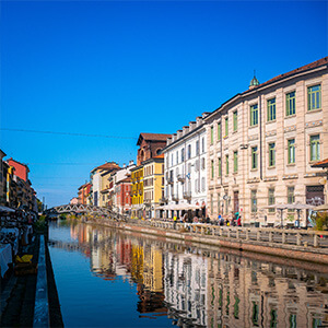 Colorful buildings reflect in the calm waters of Naviglio Grande in Milan, Italy Colorful buildings reflect in the calm waters of Naviglio Grande in Milan, Italy
