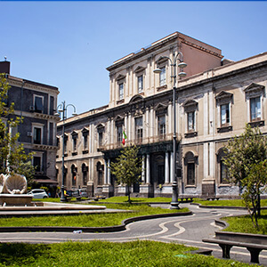 View of public school (named Convitto Nazionale M. Cutelli Liceo Classico Annesso) and city square in Catania city in Italy. View of public school (named Convitto Nazionale M. Cutelli Liceo Classico Annesso) and city square in Catania city in Italy.