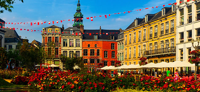 Central Grand Place Square In Mons Overlooking Baroque Belfry Of Roman Catholic Church Of St. Elizabeth Towering Over Colorful Residential Townhouses, Belgium