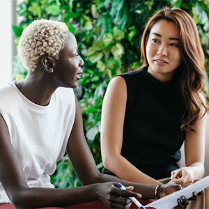 Employee reviewing a relocation assistance package with HR manager Employee reviewing a relocation assistance package with HR manager